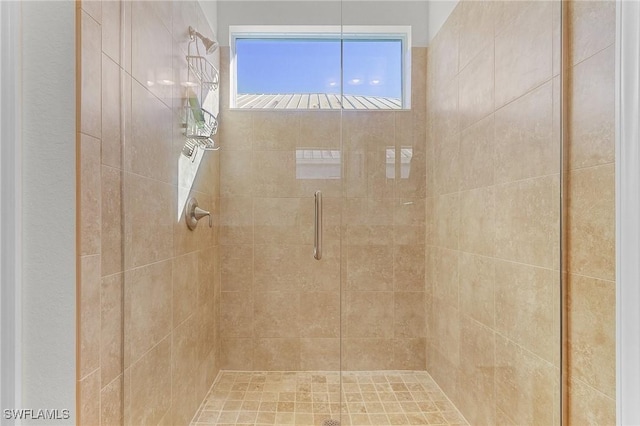 bathroom with a shower with shower door