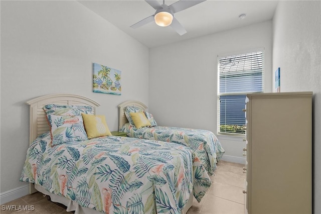 bedroom with ceiling fan and light tile patterned floors