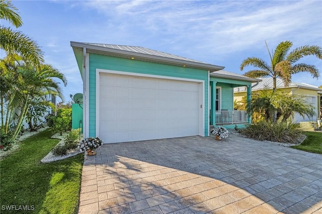 view of front of home featuring a porch and a garage