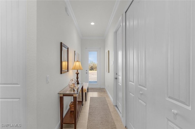 corridor with light tile patterned flooring and ornamental molding