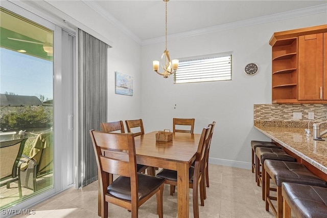 tiled dining space featuring a chandelier and ornamental molding