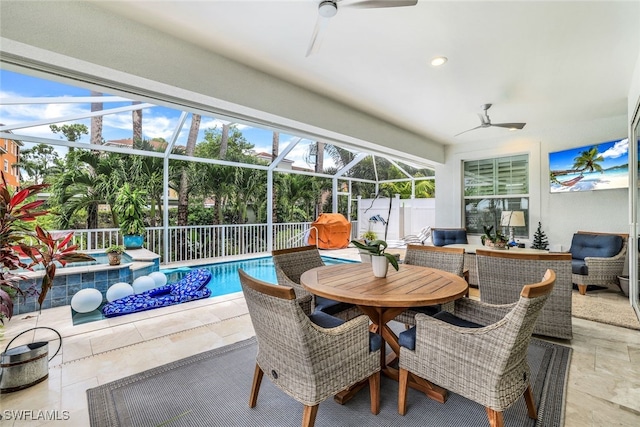 sunroom / solarium with ceiling fan and a swimming pool