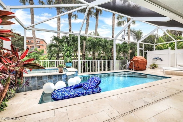 view of swimming pool with glass enclosure, a jacuzzi, and a patio