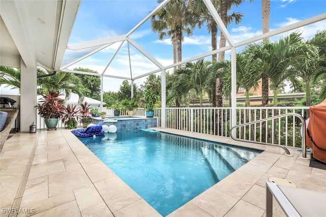 view of swimming pool with glass enclosure, an in ground hot tub, and a patio area