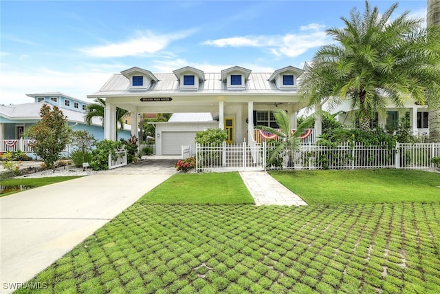 view of front of house featuring covered porch, a front yard, and a garage