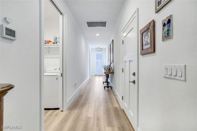 hall with washer / clothes dryer and light hardwood / wood-style floors