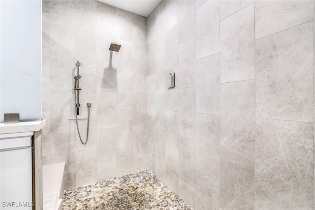 bathroom with a tile shower