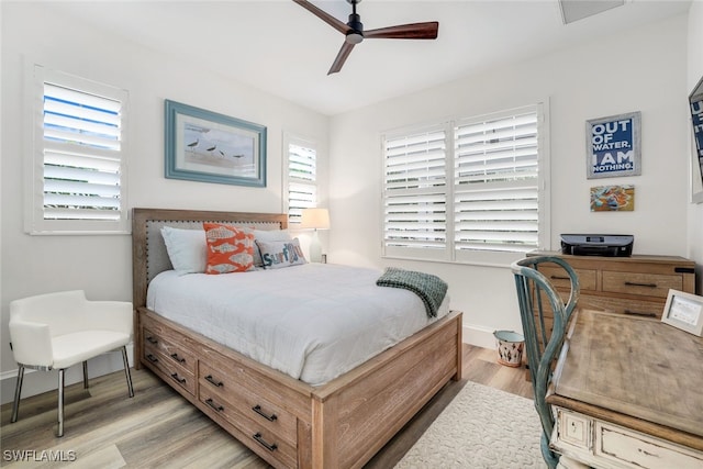 bedroom with ceiling fan and light hardwood / wood-style floors