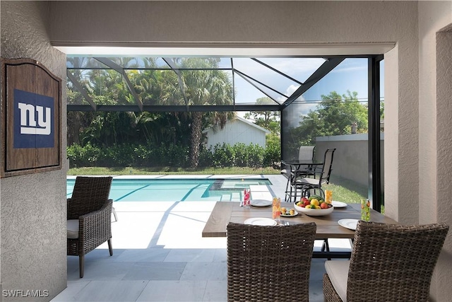 view of swimming pool with a lanai and a patio area