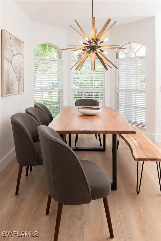 dining space with a notable chandelier and light wood-type flooring