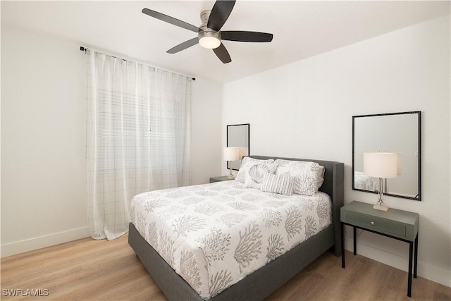 bedroom featuring hardwood / wood-style flooring and ceiling fan