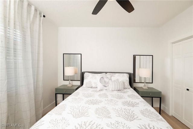 bedroom featuring a closet, ceiling fan, and hardwood / wood-style floors