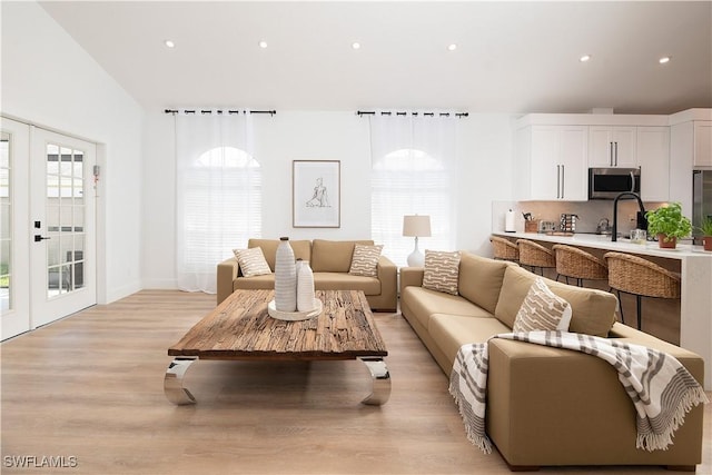 living room with french doors and light hardwood / wood-style floors