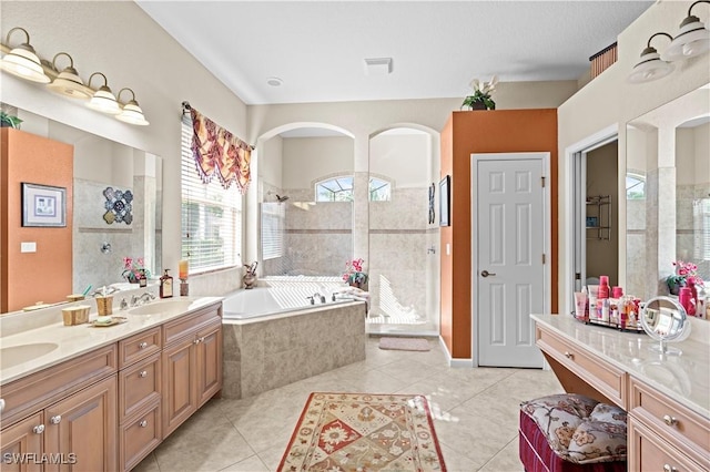 bathroom featuring independent shower and bath, tile patterned flooring, and vanity