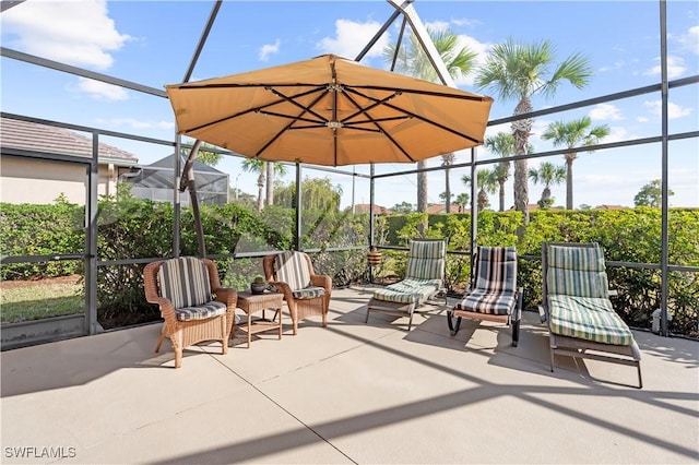 view of patio featuring glass enclosure