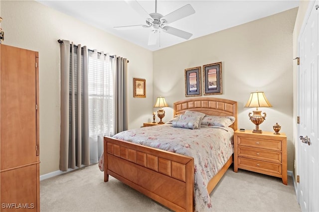 bedroom with light carpet and ceiling fan