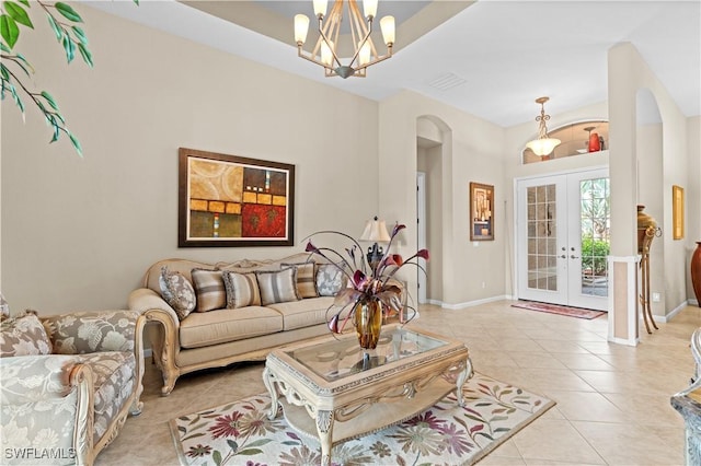 tiled living room featuring french doors and a notable chandelier