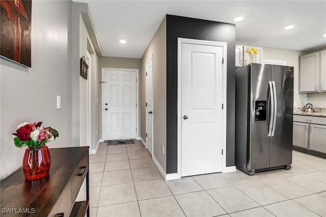 kitchen featuring stainless steel fridge with ice dispenser, gray cabinets, and light tile patterned floors