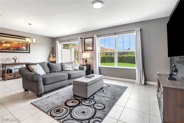 living room with a chandelier and light tile patterned flooring