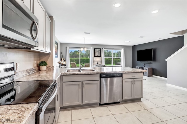 kitchen with appliances with stainless steel finishes, gray cabinetry, sink, pendant lighting, and a notable chandelier