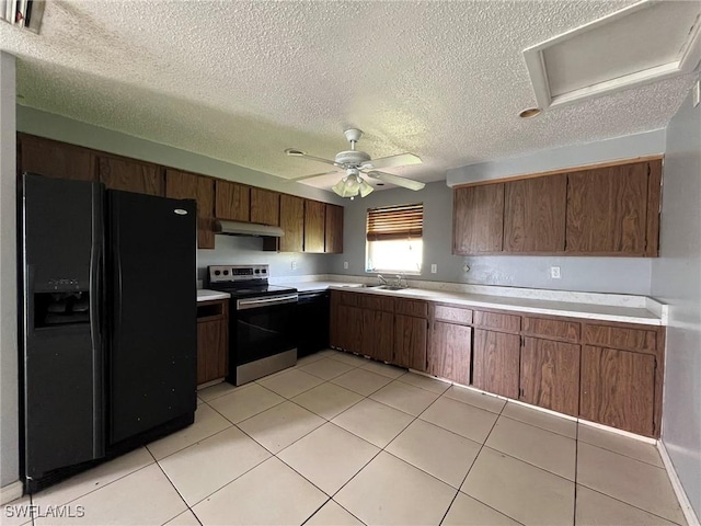 kitchen with a textured ceiling, black appliances, sink, ceiling fan, and light tile patterned floors