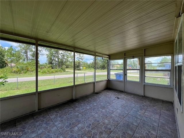 unfurnished sunroom featuring wooden ceiling and lofted ceiling