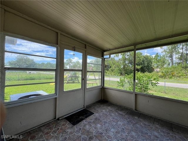 unfurnished sunroom featuring wooden ceiling