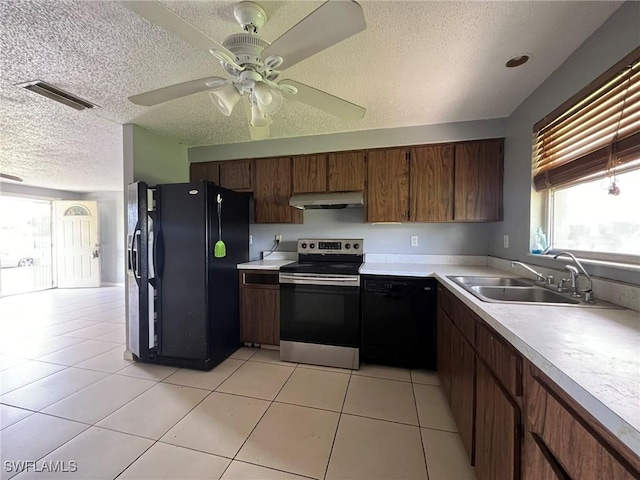 kitchen featuring ceiling fan, black appliances, sink, light tile patterned flooring, and a textured ceiling