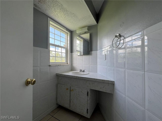 bathroom with tile patterned flooring, vanity, and tile walls