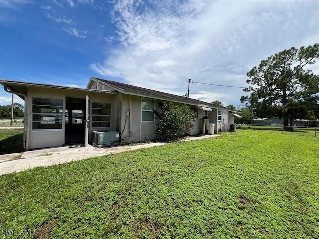 exterior space with a front lawn and a patio