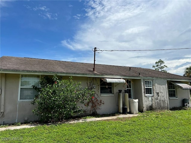 back of property featuring a yard