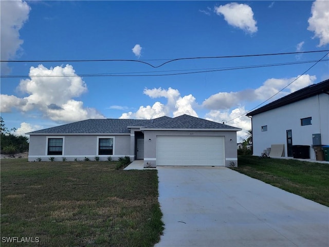 view of front of home with a front yard and a garage