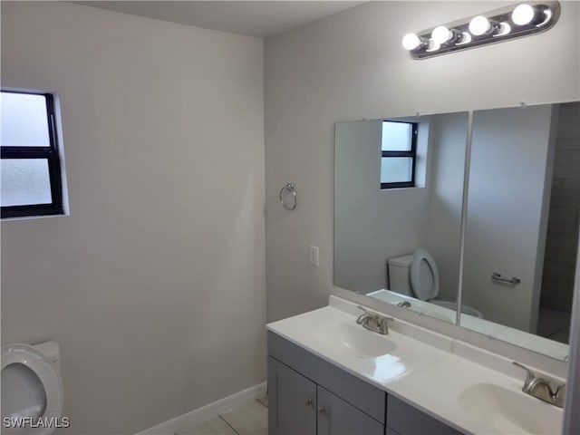 bathroom with tile patterned floors, vanity, and toilet