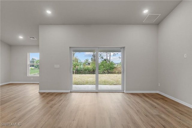 spare room with light hardwood / wood-style flooring and plenty of natural light