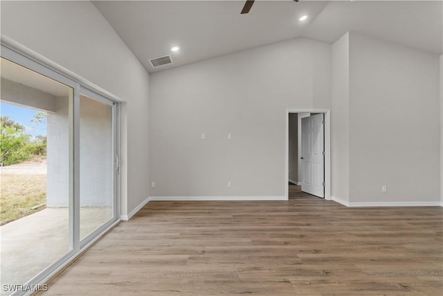 unfurnished room with lofted ceiling, ceiling fan, and light hardwood / wood-style flooring