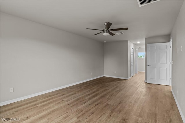 empty room with ceiling fan and light hardwood / wood-style floors