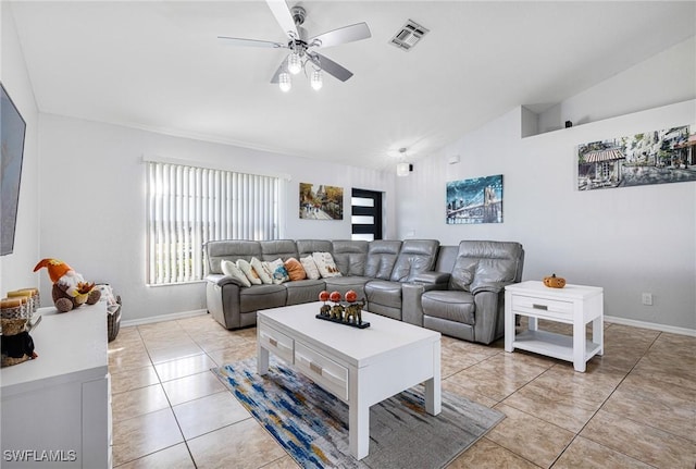 living room featuring light tile patterned floors, vaulted ceiling, and ceiling fan