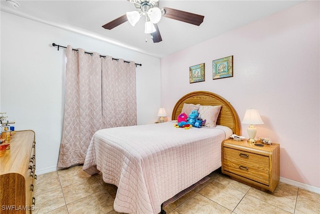 bedroom with ceiling fan and light tile patterned flooring