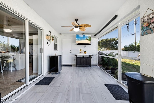 sunroom / solarium with ceiling fan