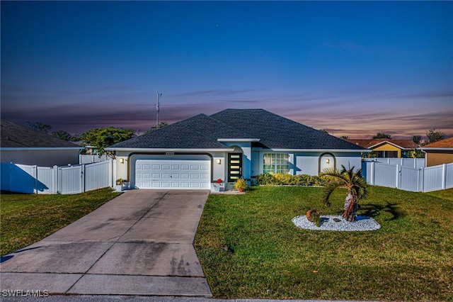 view of front of house with a lawn and a garage