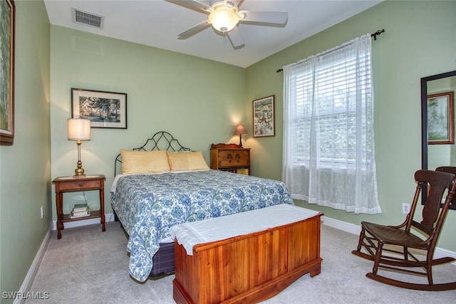 bedroom featuring ceiling fan and light carpet