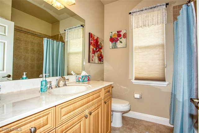 bathroom featuring toilet, vanity, and tile patterned flooring