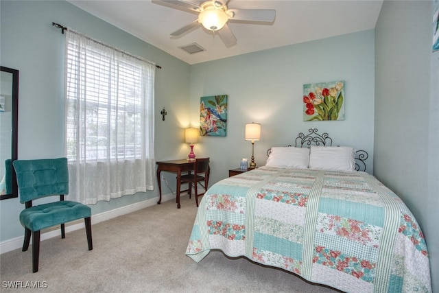 bedroom with ceiling fan and light carpet