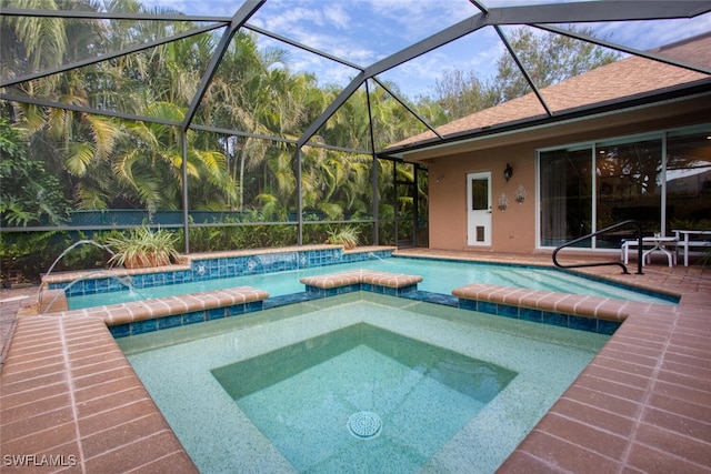 view of pool featuring a lanai and an in ground hot tub