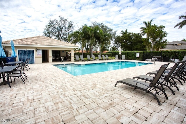 view of swimming pool with a patio area