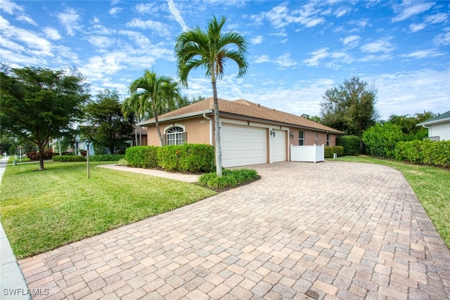 view of front of property featuring a front lawn and a garage