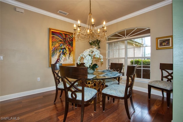 dining space featuring dark hardwood / wood-style flooring, ornamental molding, and a chandelier