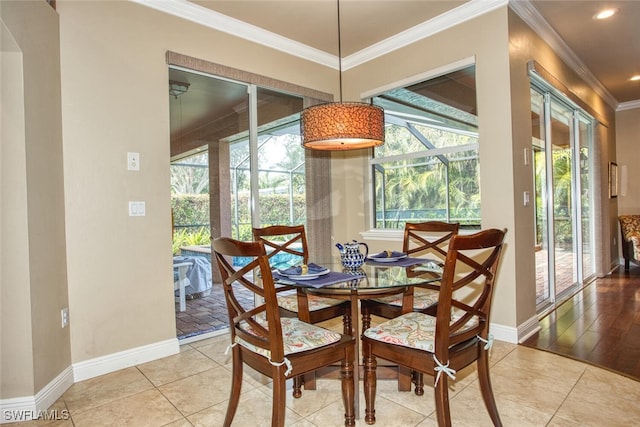 tiled dining area featuring crown molding