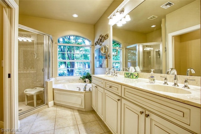 bathroom with tile patterned floors, vanity, and separate shower and tub