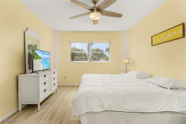 bedroom with ceiling fan and light hardwood / wood-style flooring